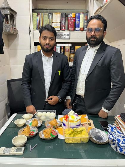 Standing with my mentor on Teacher's Day, surrounded by sweets and snacks.