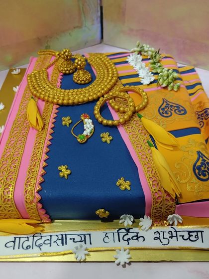 A stunningly realistic Paithani saree cake. Every fold, border, and piece of jewelry is handcrafted from fondant to replicate the traditional Maharashtrian saree.