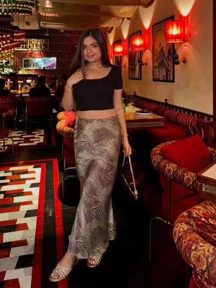 The full evening look with the satin skirt, showing how a single piece can be styled for different occasions.