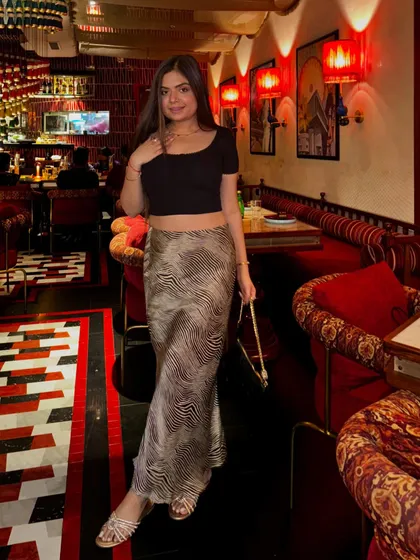 The full evening look with the satin skirt, showing how a single piece can be styled for different occasions.