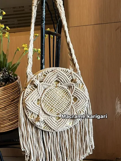 A variation of our round macramé bag in an off-white color. It’s a timeless piece that pairs well with everything, perfect for a day out or a beach vacation.