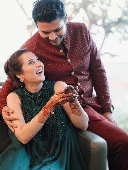 The easy laughter between Sushant and Akanksha. This candid portrait captures their genuine connection and the joy they share, a beautiful memory from their Mehendi celebration.