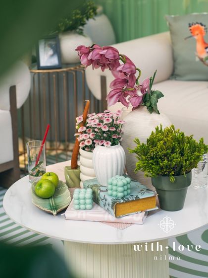 A tabletop detail from the baby shower, with bubble candles, books, and small floral arrangements creating a charming vignette.