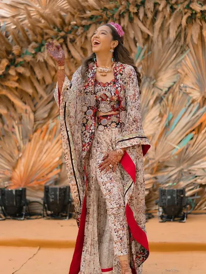 The bride looking joyful and radiant, her wavy hair perfectly matching the fun, boho vibe of her outfit.