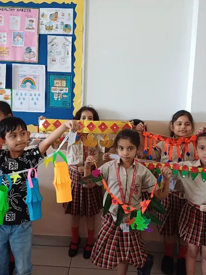A group of young students shows off the festive 'torans' (door hangings) and lanterns they made. Our Diwali craft sessions are filled with color, creativity, and festive cheer.