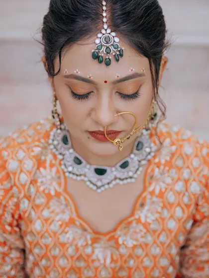 A close-up of my signature bridal makeup. Notice the seamless blend, the soft shimmer on the eyes, and the perfectly defined brows. I focus on these details to create a look that's flawless both in person and in photos.