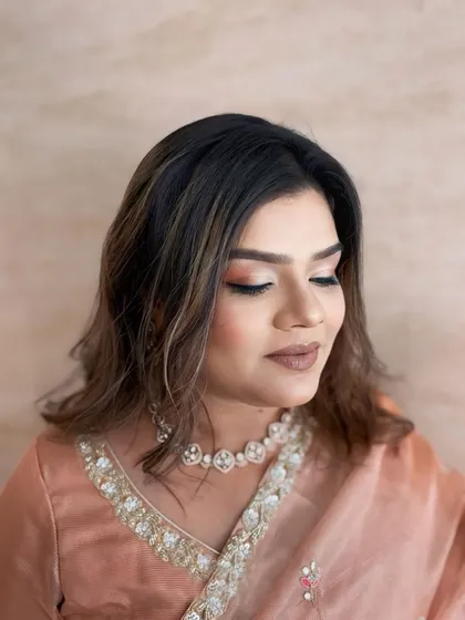 A close-up of the soft, peachy-nude eye makeup. It's a versatile look that complements many different outfits.