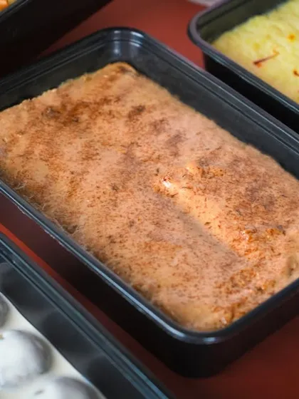Two of my signature desserts, the Coffee Crème Shahi Tukda and the Saffron Bread Pudding, packed in convenient party-sized containers.