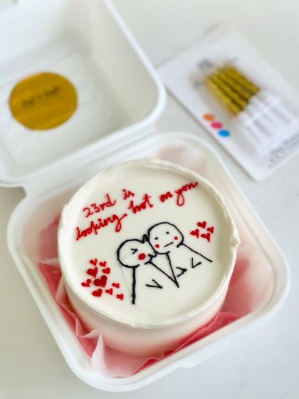 A birthday cake with a flirty message. The hand-drawn stick figures and "23rd is looking hot on you" text make this a unique and personal celebration cake.
