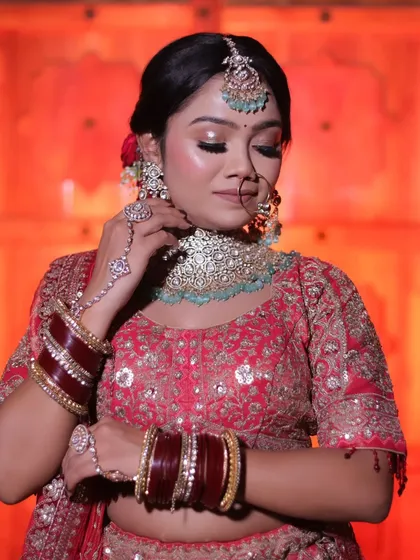 A portrait focusing on the bride's delicate hand gesture, drawing attention to the hand jewelry and choker necklace.