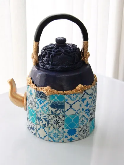 Yes, it's a cake! This is my edible teapot, inspired by Turkish and Moroccan art, which I created for a cake show. Each tile was individually placed to create the intricate pattern.
