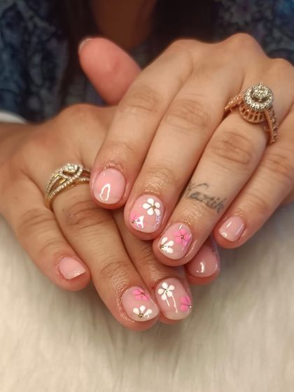 A recap photo showing a delicate floral design on short, natural nails.