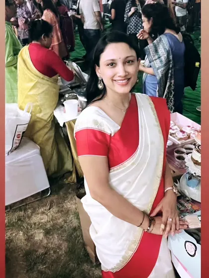 Feeling the festive spirit in my red and white saree at the Durgotsav pop-up. It's such a blessing to be part of these beautiful traditions.