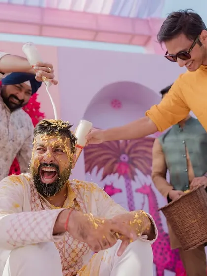 A high-energy shot of the groom's Haldi, with friends surrounding him and having a great time.