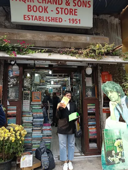 Holding up my new book outside the store, completing my New Year's tradition.