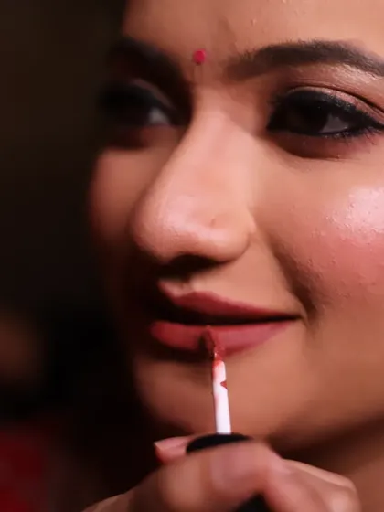 Applying lipstick is one of the final, transformative steps. I use a precise brush to ensure a perfectly defined and long-lasting lip.