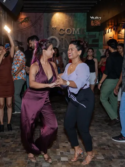 The magic of our socials is in the connections you make. Here, two dancers share a moment, lighting up the floor with their energy. It's a welcoming space for everyone to lead, follow, and have fun.