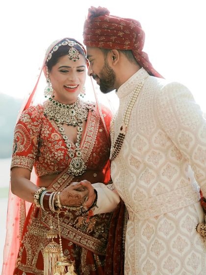 An intimate close-up of the couple holding hands, their faces filled with love and happiness. The soft, bright light adds to the romantic feel.