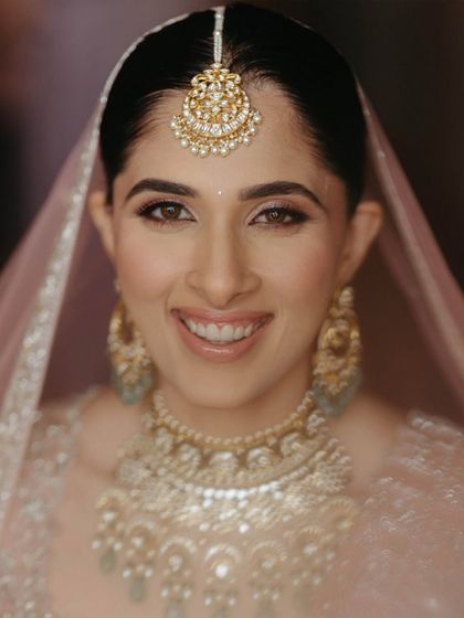 A happy, smiling close-up of the bride. Her joy is palpable, and her makeup is fresh and radiant.