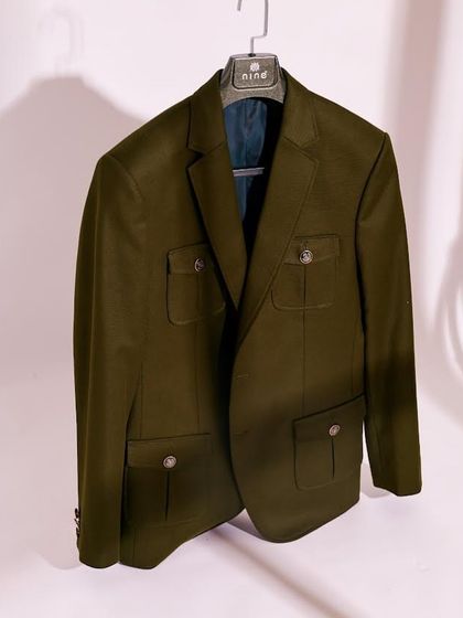 Our olive green coat is designed to be both stylish and practical. Made from a premium, breathable fabric, it's a versatile essential for any wardrobe.