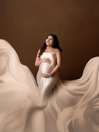 A dreamy, artistic portrait with a flowing satin gown. The soft, creamy tones and the movement of the fabric create a beautiful and timeless image.