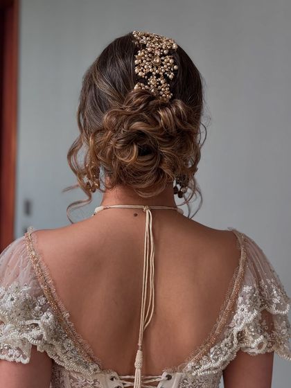 Another angle of the messy updo with a statement hairpiece.