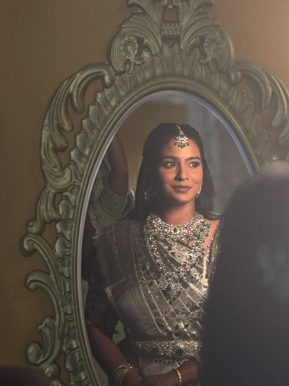 A creative shot of my Chennai bride Sruthi, captured through a mirror. Her reception makeup is glamorous and glowing, perfect for the grand setting.