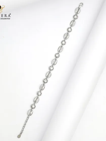 A delicate silver bracelet with alternating polished and sparkling charms. This design is versatile and speaks to a subtle, elegant style.