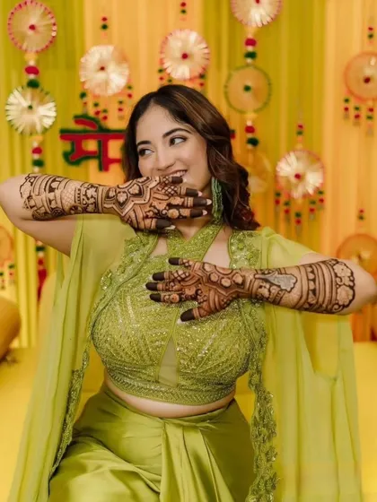 Nothing makes me happier than seeing a client light up with joy. Here's a happy client at her mehendi function, showing off her full-coverage henna. The design is perfect for the festive, celebratory atmosphere.