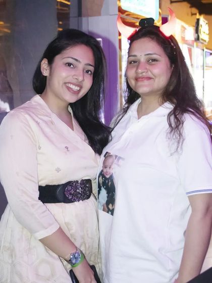 Two guests smiling for a photo at a party. We make sure to get great shots of the people who made your day special.