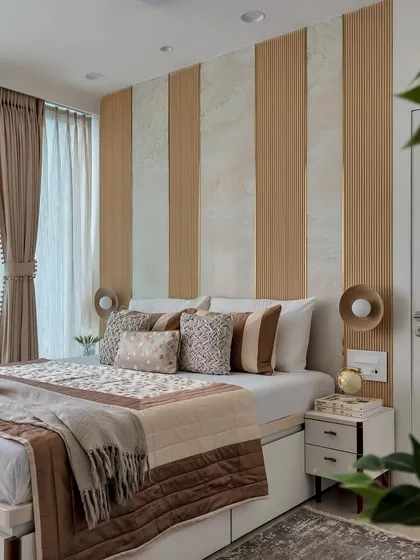 This earth-toned bedroom is a haven of calm. The striped wood and plaster wall behind the bed adds texture, while the mix of brown and beige bedding creates a warm and inviting look.