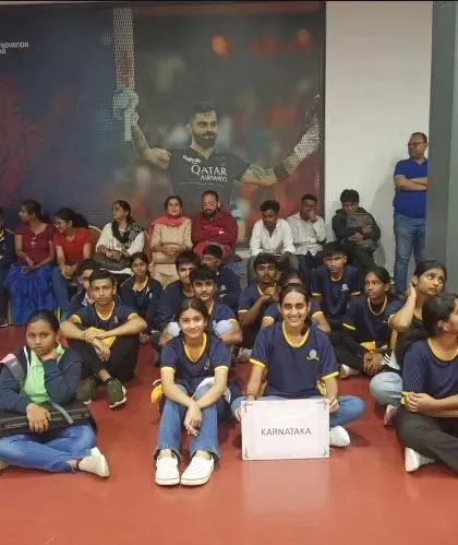 Team Karnataka pictured together at the venue, representing the home state with pride during the national competition.