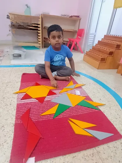 This is the essence of how we learn mathematics. A child explores geometry using the Montessori Constructive Triangles, discovering how shapes fit together not by memorizing rules, but through tangible, hands-on exploration.