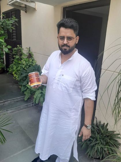 Another satisfied customer posing with our complimentary gift mug. It's a small way for us to say shukriya.