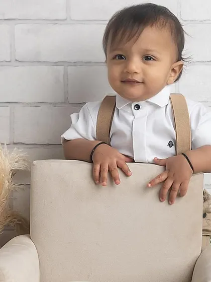 Standing tall and proud! This little one is exploring his first birthday setup, showing off his new standing skills.