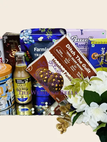 A detailed shot of the goodies in our snack-filled Rakhi hamper. It includes everything from Pringles and popcorn to cold brew and guilt-free cookies.
