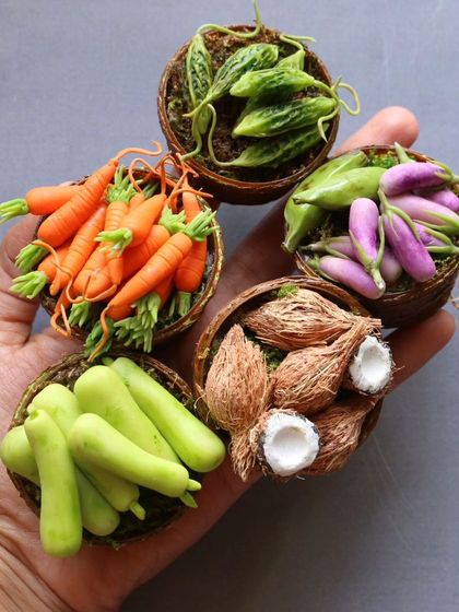 A handful of my miniature vegetable baskets, including carrots, brinjal, and coconuts.