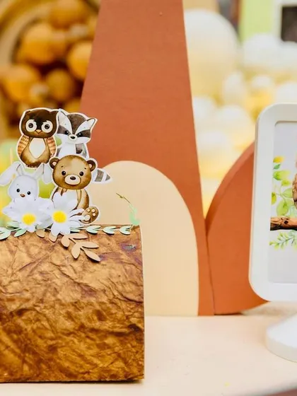 More delightful details from the woodland theme, featuring a framed owl picture and miniature animal cutouts, showcasing the thought put into every element.