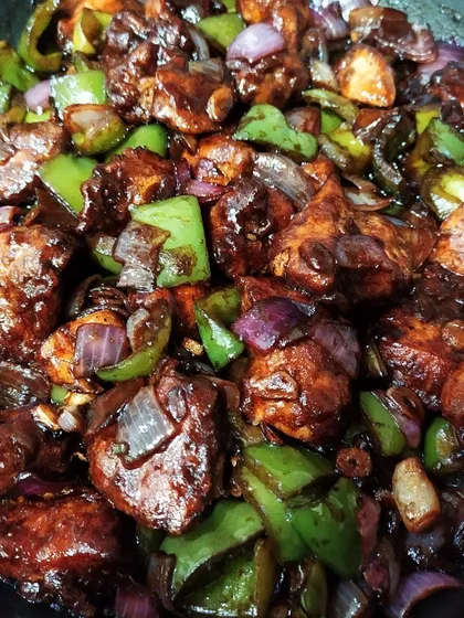 My take on the famous Kolkata-style Chilli Chicken. It's spicy, tangy, and full of flavour, with succulent chicken pieces tossed with crisp onions and bell peppers. This dish shows the wonderful influence of Tangra's Chinese food on Bengali cuisine.