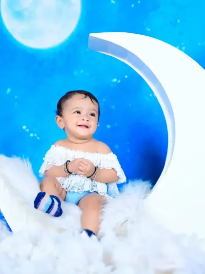 A beautiful shot from the "baby on the moon" theme, with the baby looking up with a joyful expression.