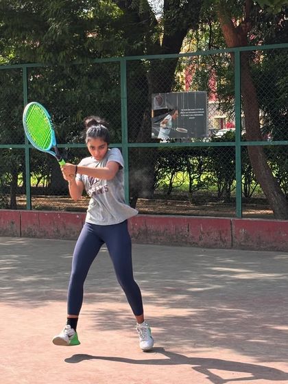 A player mid-swing during a practice session. The focus and determination are clear, all part of the supportive training environment we foster.