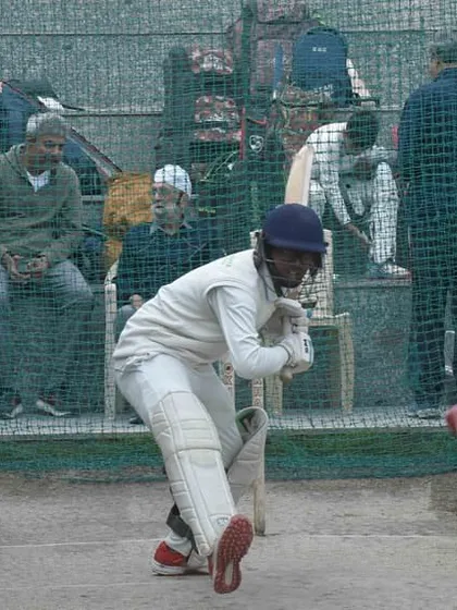 A student's focus during a net session is sharpened by the presence of a legend. Former Indian cricketer Ajay Jadeja observes a young batsman, offering the kind of mentorship that is unique to our academy.