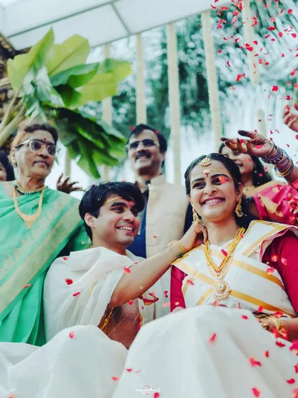A beautiful, happy moment from a Mahurtham ceremony, with the family showering the couple with love and petals.