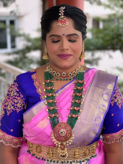 The eye makeup is soft yet defined, perfect for a daytime celebration.