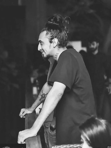 A candid black and white shot of me looking out from the DJ booth, taking in the energy of the room before the next track.