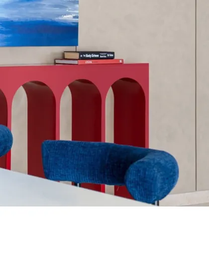 A detail of the bold red console and blue dining chairs. This image highlights the rich, saturated colors and clean, curved forms that we often use to make a statement.