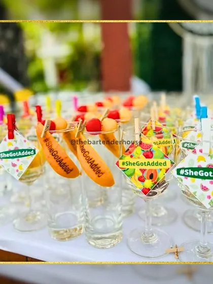 We get creative with every part of the drink, including the garnish. Here you can see "SheGotAdded" carefully engraved on orange peels for a bridal shower.