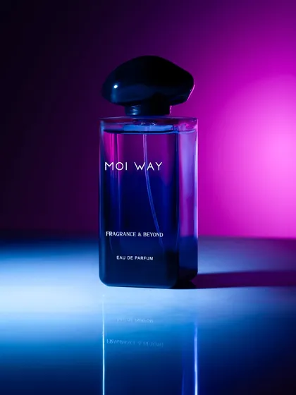 Using colored gels to light this perfume bottle with a vibrant pink and blue gradient. This technique creates a futuristic, neon-noir mood that is modern and eye-catching.