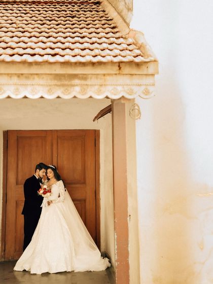A quiet, intimate portrait of the couple framed by a doorway. This shot feels personal and timeless, highlighting their connection.