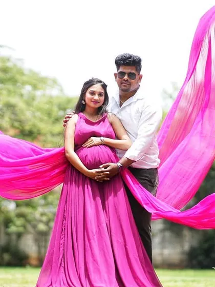 Celebrate your special journey with my collection of maternity photoshoot gowns. This flowing magenta dress with a long trail is designed to be comfortable while creating beautiful, ethereal portraits of you and your bump.